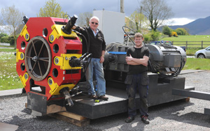 Liam & Hugh O’Connor in front of the Integrated Wood Pellet System ready to ship on a pallet